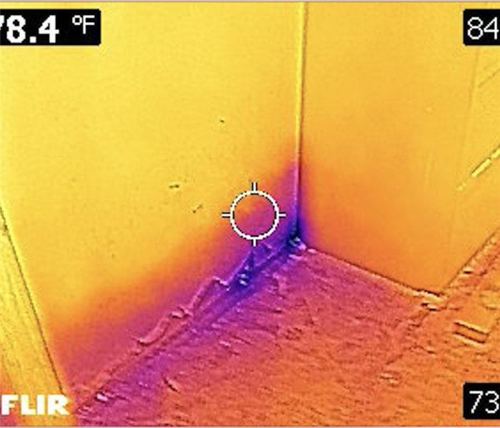 Infrared camera spotting moisture in a corner of a wall.