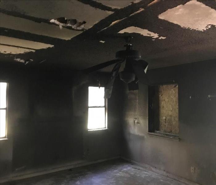 Severe fire and soot damage to empty room in Austin, TX.