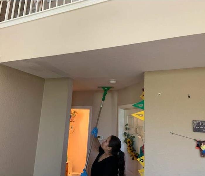 Team member cleaning ceiling.