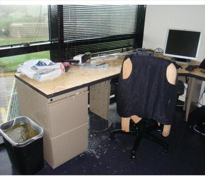 Desk in office with severe water damage.
