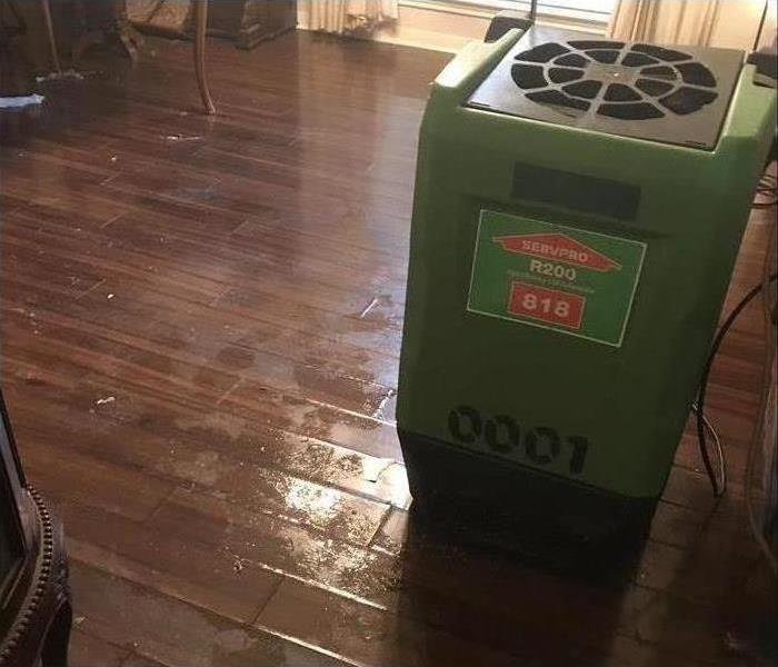 dehumidifier placed on a room, floor is being dried up.